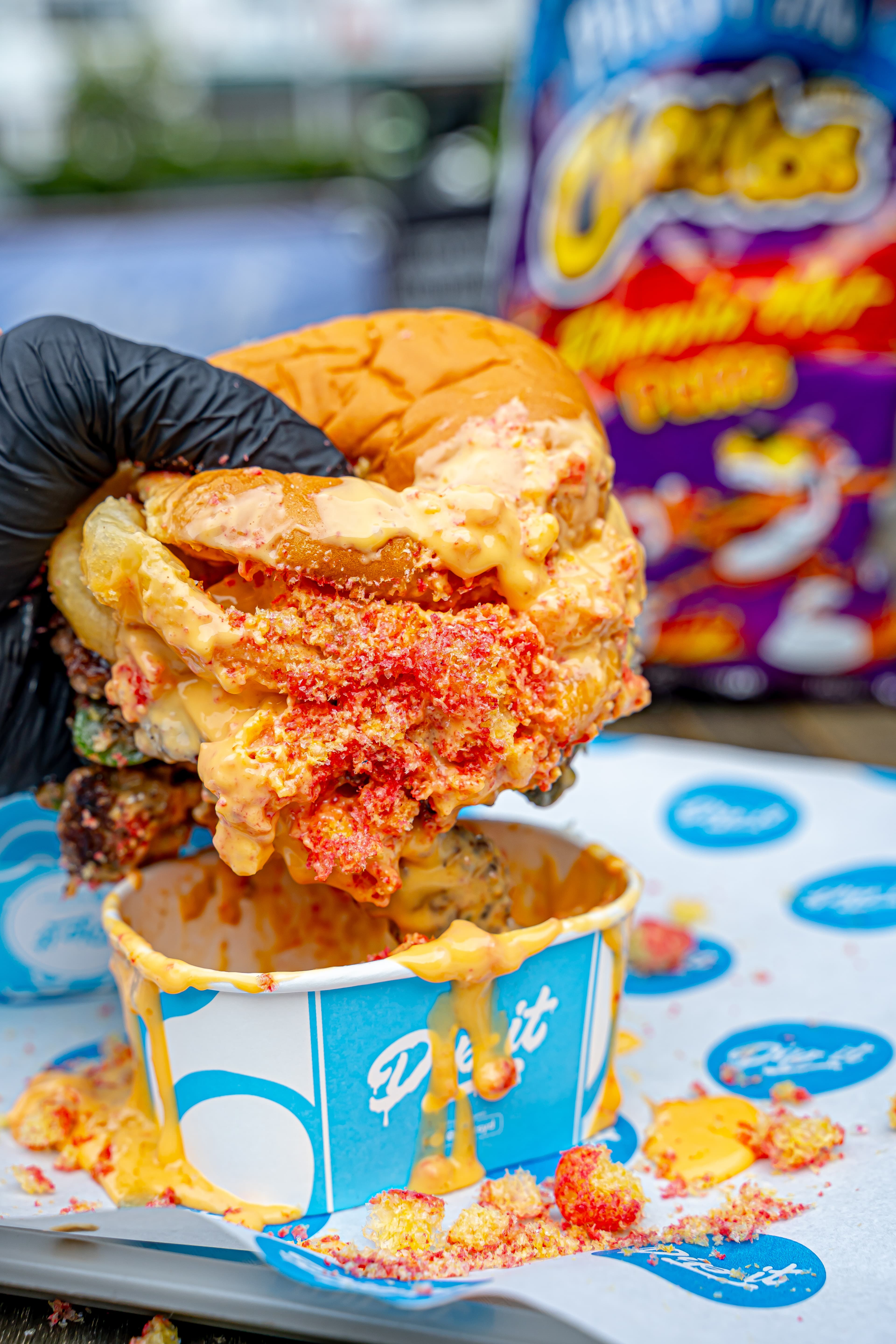 Flamin' Hot Fozball lifted dripping with Cheetos queso